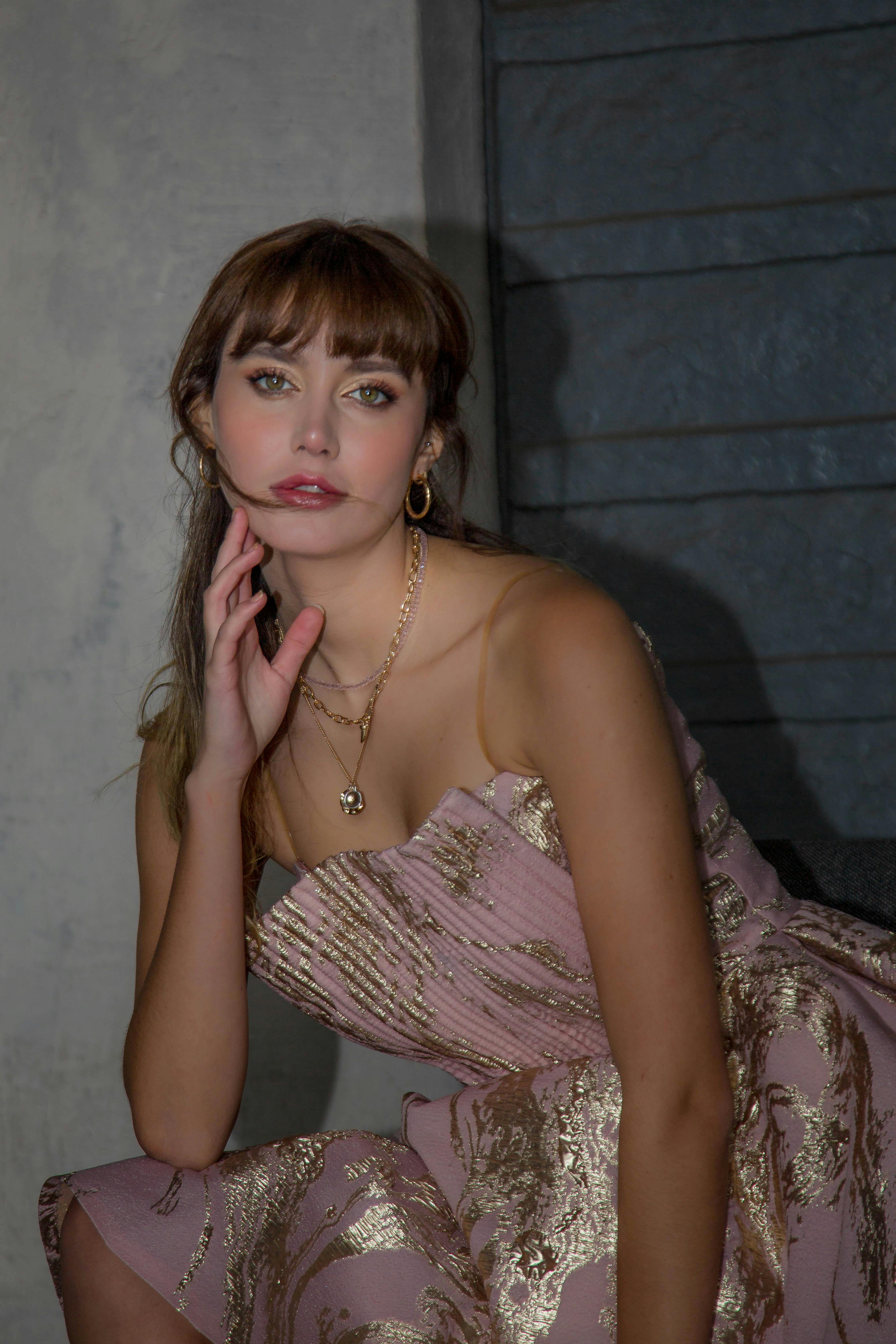 Model wearing a pink and gold dress