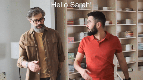 GIF of two men walking side by side with the text "Hello Sarah!" overlayed at the top